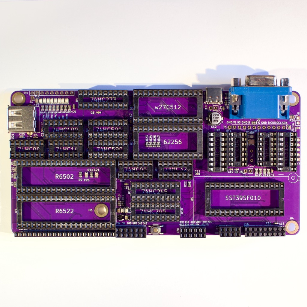 Populated purple ABN6502 r2 board, with CPU, 6522 VIA, memory and VGA connector
